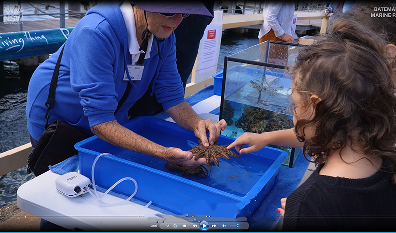 Teacher showing students a starfish