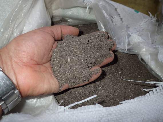 A hand with composted cow manure in the palm
