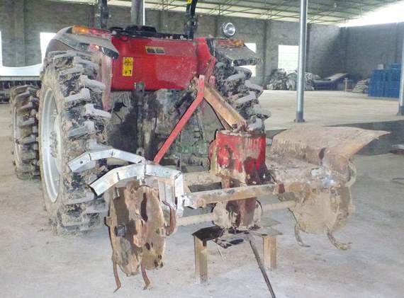 A tractor with a rotary hoe implement