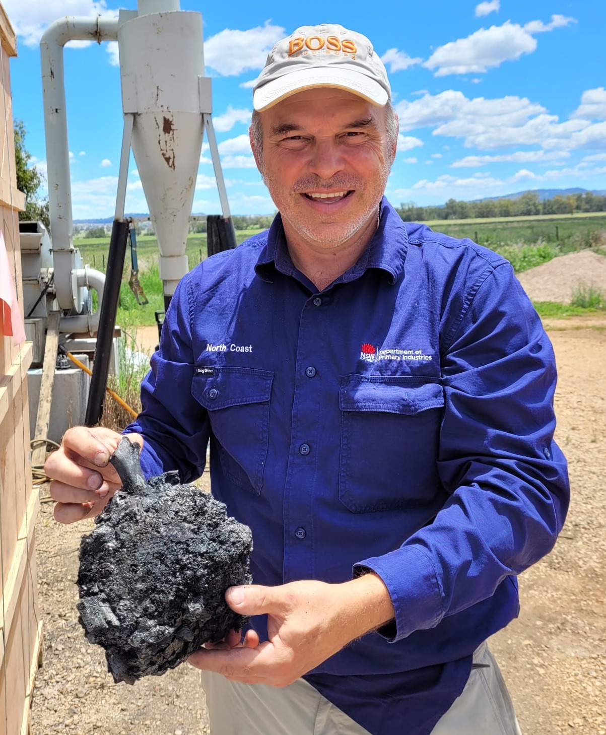 Dr Lukas Van Zwieten holding a piece of biochar